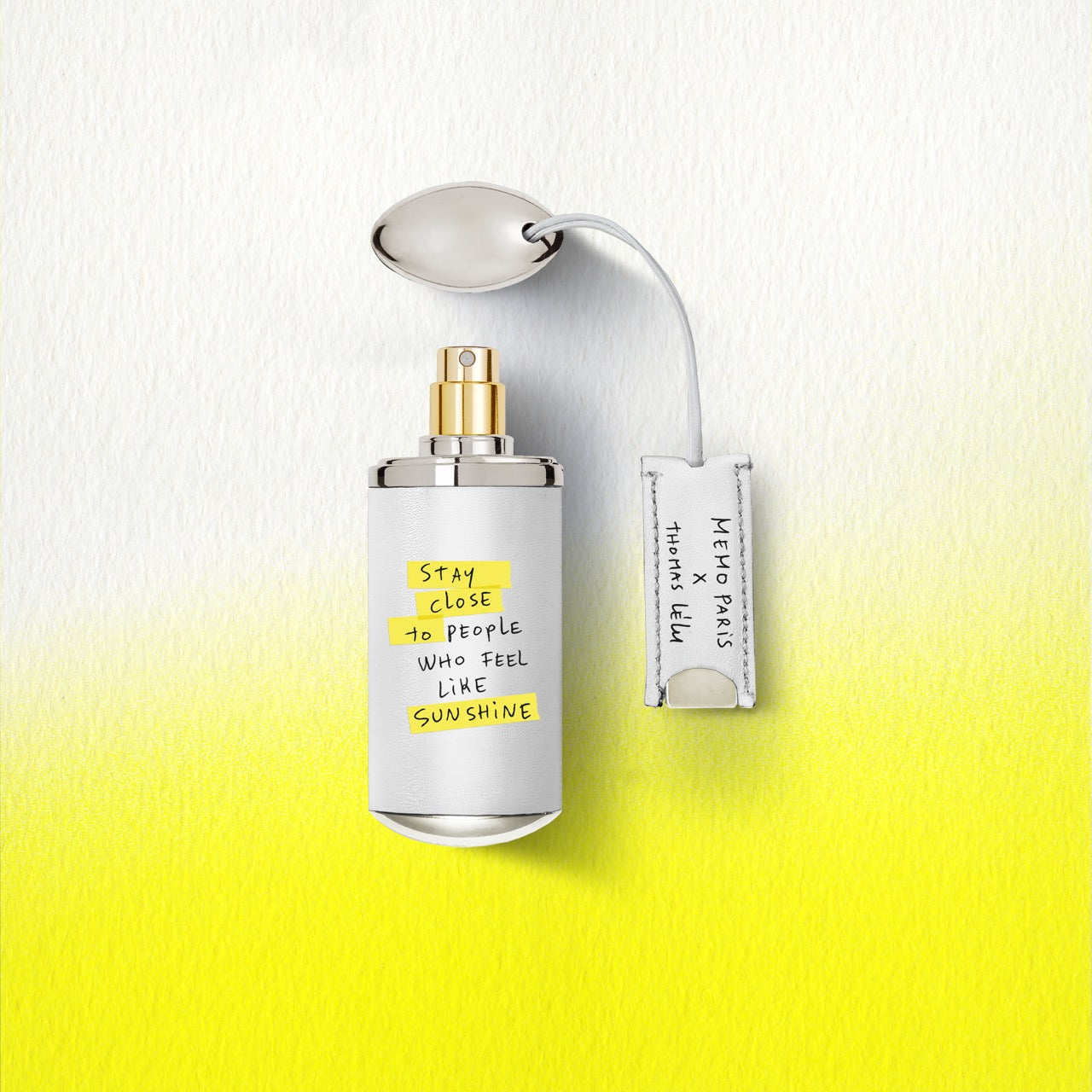 A sleek white darling point perfume bottle by memo paris with gold spray nozzle silver cap in 10ml travel size — vue alternative