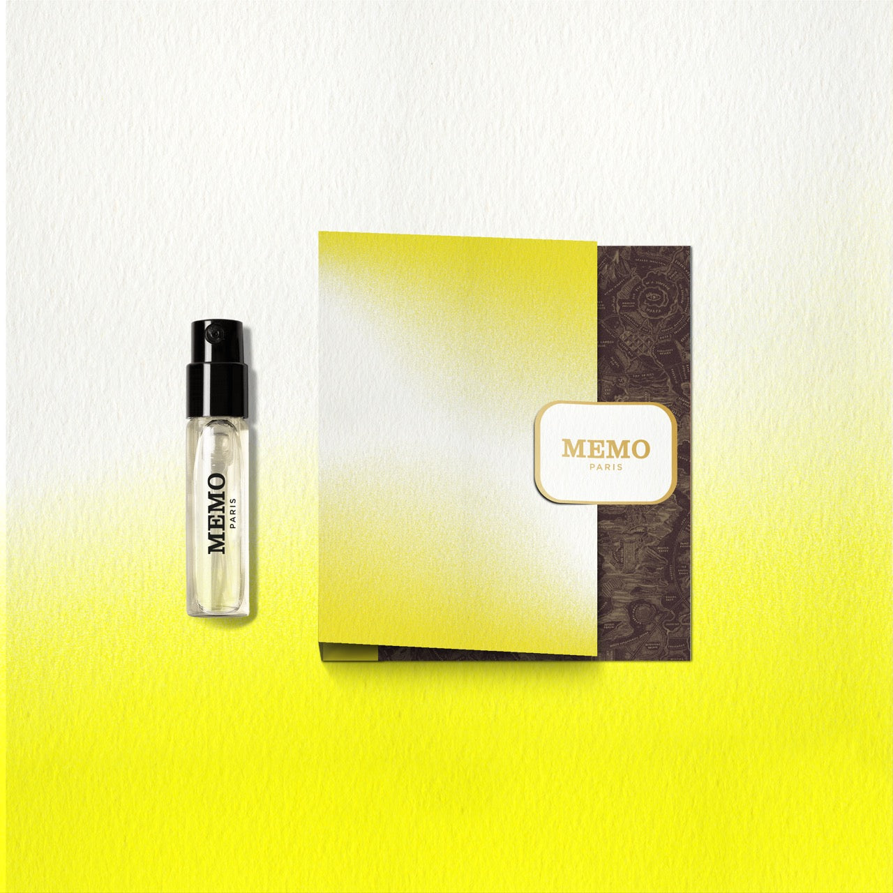 A sleek transparent glass perfume vial with black spray nozzle labeled memo paris from the new destination collection