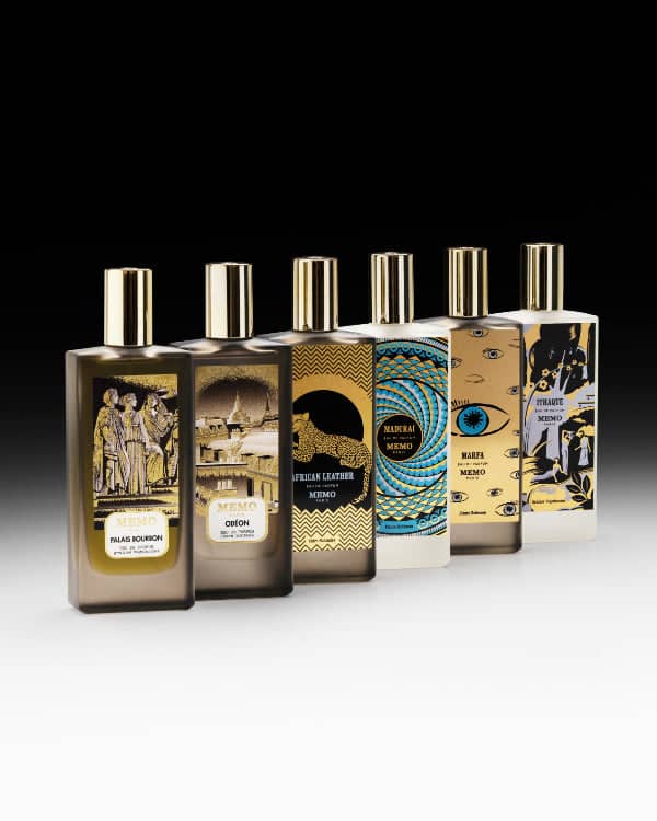 Six rectangular perfume bottles from the memo brand, each with a gold cap and unique illustrated labels in various colors including brown, beige, black, blue, and white.