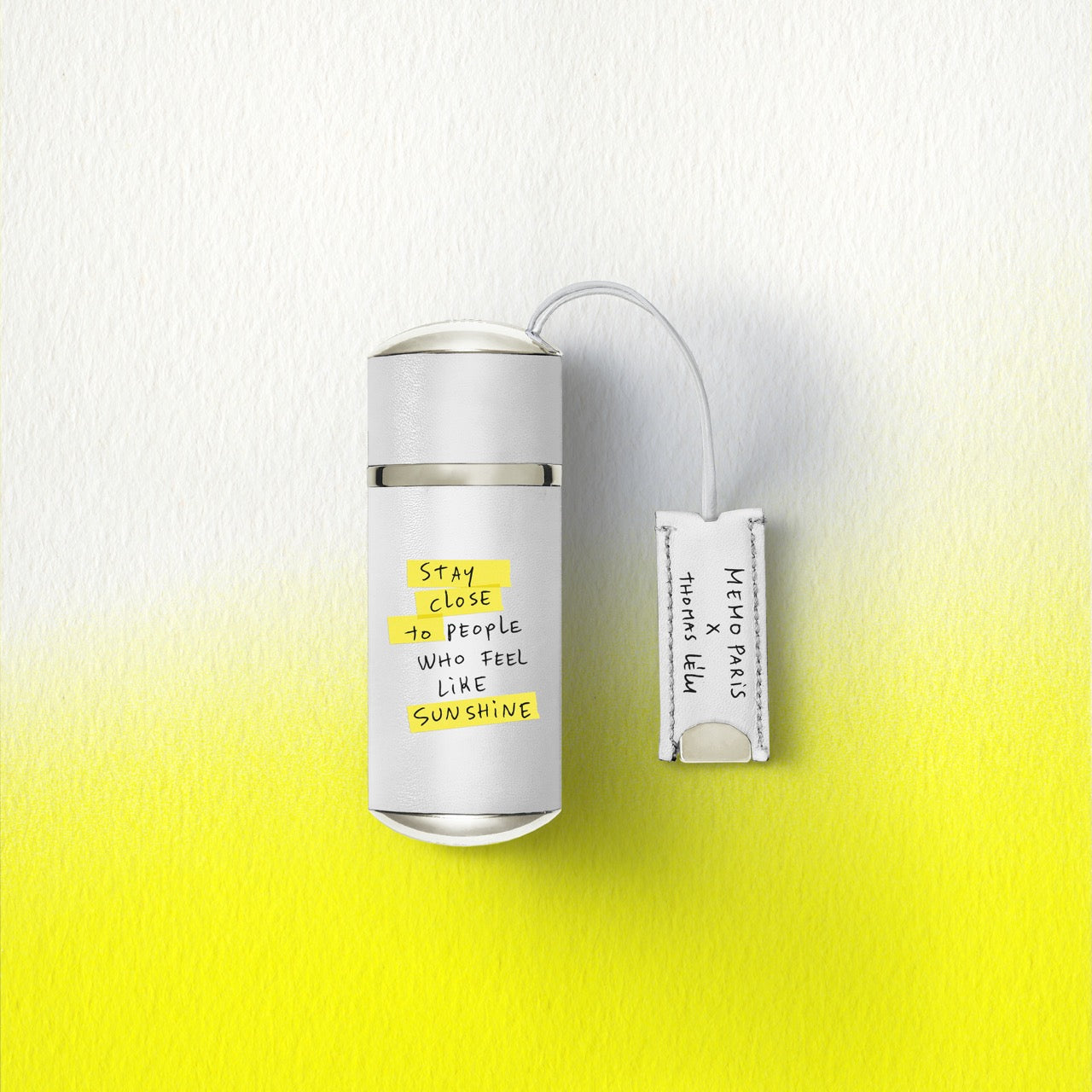 White cylindrical memo paris darling point perfume bottle with silver cap 10ml travel size matte finish and yellow text